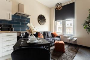 a living room with a couch and a table at Crown Street Aparthotel in Halifax