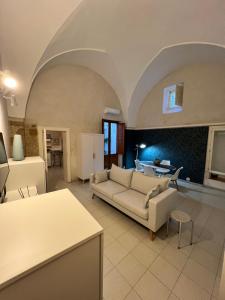 a living room with a couch and a table at Handy Pergola in Brindisi
