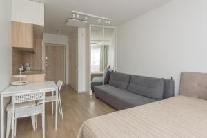 a living room with a couch and a table in a room at Malūno vila 777 in Palanga
