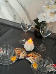 a table with wine glasses and snacks and a candle at 2-ух комнатная люкс квартира in Balqash +2 photos