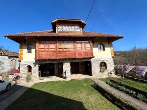 a large house with a red roof at Country house Todor in Kragujevac