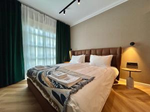 a bedroom with a large bed with green curtains at Hotel Akureyri in Akureyri