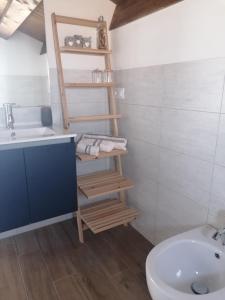 a bathroom with a white sink and a toilet and a sink at Ca' Libellula Casa Vacanza in Avola