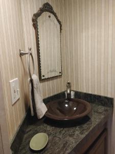 a bathroom with a sink and a mirror at Inn at Ellis River in Jackson