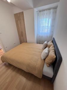 a bedroom with a large bed with a window at Central Luxe in Banja Luka