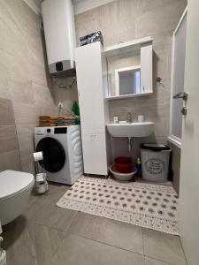 a bathroom with a sink and a washing machine at Central Luxe in Banja Luka +11 photos