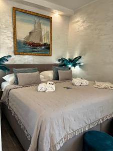 a bedroom with a large bed with towels on it at La Dolce Vita Apartments in the city center with private parking in Pula