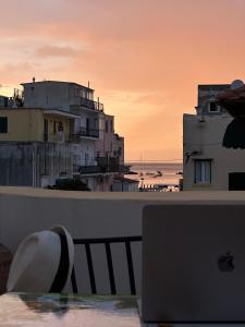 an apple laptop sitting on a table with a view of the ocean at Hotel Da Raffaele in Ischia