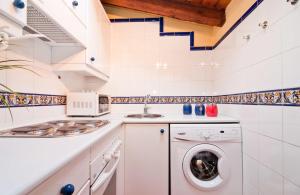 a white laundry room with a washer and dryer at Atico Preciados in Madrid