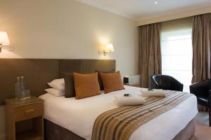 A bed or beds in a room at Forest Lodge Hotel 