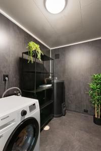 a laundry room with a washing machine in it at Central and newly renovated apartment for rent in Tromsø