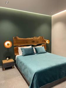 a bedroom with a large bed with a wooden headboard at Voyage Apartment in Himare