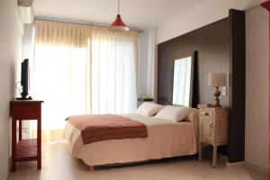 Miliño Apart Hotel tesisinde bir odada yatak veya yataklar