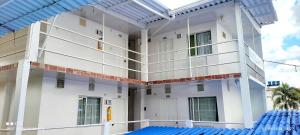 an external view of a building with a pool at HOTEL NUEVO GALEX in Acacías
