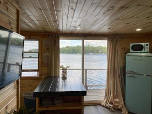 a kitchen with a table and a view of the water at Lake Victoria Resort in Alexandria