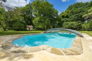 a large swimming pool with a cover over it at Gîte de Lamourelle in Lacquy