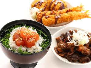 a group of bowls of food on a table at Dormy Inn Express Mikawaanjo in Anjomachi
