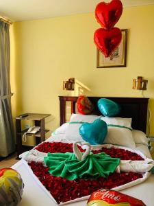 a bedroom with a bed with hearts and flowers on it at Dos Hemisferios in Quito