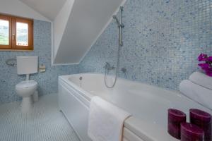 a bathroom with a white tub and a toilet at Apartments Vallum in Bol +67 photos