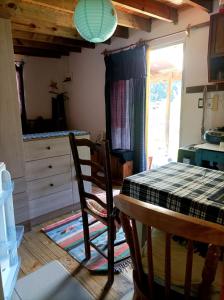 a kitchen with a table and chairs in a room at Cabaña Pitiayumí in Villa Serrana +38 photos