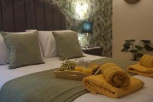 Una cama con toallas y una bandeja de zumo de naranja. en Central Riverside Apartment, en Bristol 31 fotos más