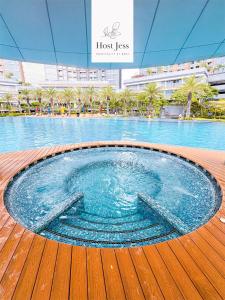 a large swimming pool in the middle of a building at Gold Coast Apartment PIK Lovely Stay Near Airport in Jakarta