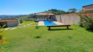 a backyard with a pool and a gazebo at Rancho do Carlinhos in Ipoema