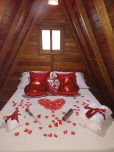 a bed in a room with red hearts on it at Recanto Quina da Mata in Santo Antônio do Pinhal +28 photos