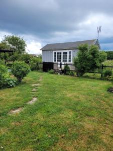 a house with a yard with a grass field at Helgas stuga i Jonstorp in Jonstorp +40 photos