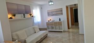 a living room with a couch and a table at Vivienda vacacional a 10 minutos de la capital. in Arucas