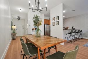 a kitchen and dining room with a wooden table and chairs at Trendy Retreat - Great Location - Fully Loaded in Kissimmee