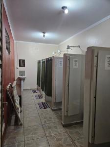 a row of refrigerators are lined up in a room at Cabana Hostel nas Árvores EcoPark in São Pedro