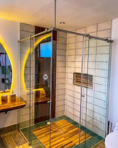 a shower with a glass door in a bathroom at Santuario Deluxe in Trujillo