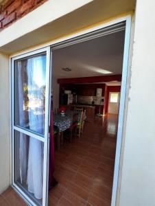 a sliding glass door to a dining room with a table at Apart Hotel Chilecito in Chilecito