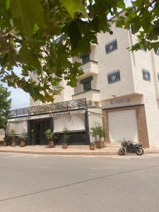 a motorcycle parked in front of a building at Le ruban d’or in Azilal