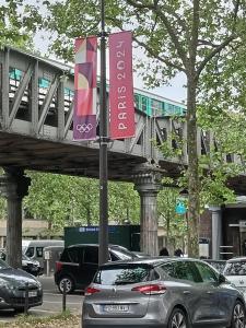 a sign on a pole in a parking lot with cars at Chambre double confort in Paris +1 photo