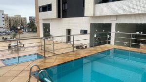 a swimming pool on top of a building at Praia Litorânea in São Luís