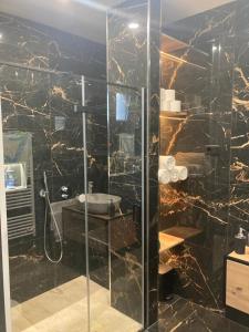 a bathroom with a glass shower with a sink at Family friendly house with a swimming pool Biograd na Moru, Biograd - 23272 in Biograd na Moru