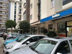 a row of cars parked in front of a dealership at Hurem apartment City kvart in Podgorica