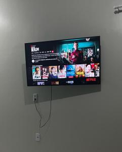 a flat screen tv hanging on a wall at Villa brisa icaraizinho suíte premium 1 andar in Amontada