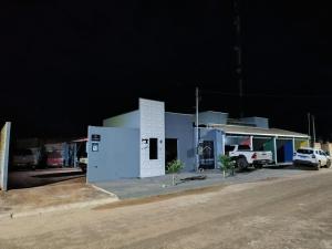 a blue building with a truck parked in front of it at FlatsMedrado Hotel in Confresa +7 photos