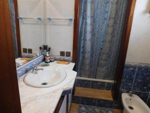 a bathroom with a sink and a shower at Appartement moderne à 5 min de la plage in Cabo Negro +18 photos
