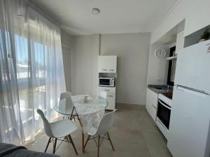 a kitchen with a table and chairs in a room at Departamento Margui in San Pedro