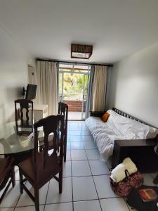 a bedroom with a bed and a desk and a table at Gran lençóis Flat Residence in Barreirinhas
