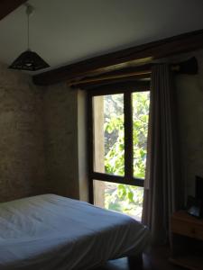 a bedroom with a bed and a window at Les Gîtes De La Chérine in Quinson