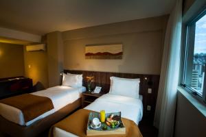 Cama ou camas em um quarto em BH Raja Hotel