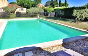a swimming pool with blue water in a yard at La Villa Du Colombier in Barbentane