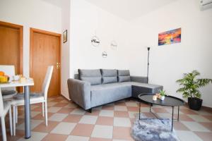 a living room with a couch and a table at Ibeach By Rok Apartment in Novigrad Dalmatia
