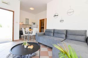 a living room with a couch and a table at Ibeach By Rok Apartment in Novigrad Dalmatia