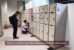 two men looking at lockers in a building at KITAZAWA CS HOUSE / Vacation STAY 78552 in Tokyo
